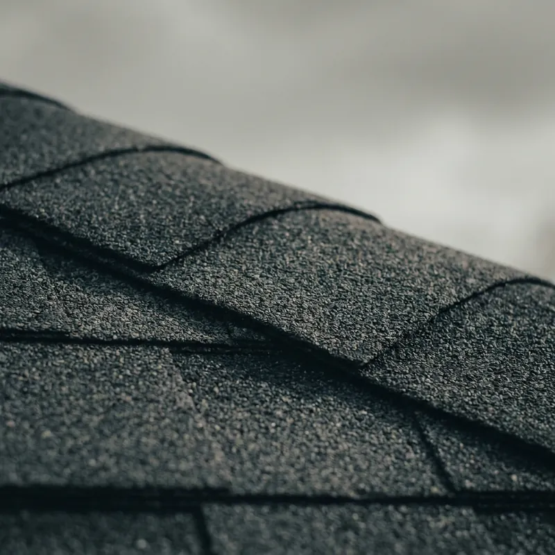 Roofer installing shingles on a residential roof